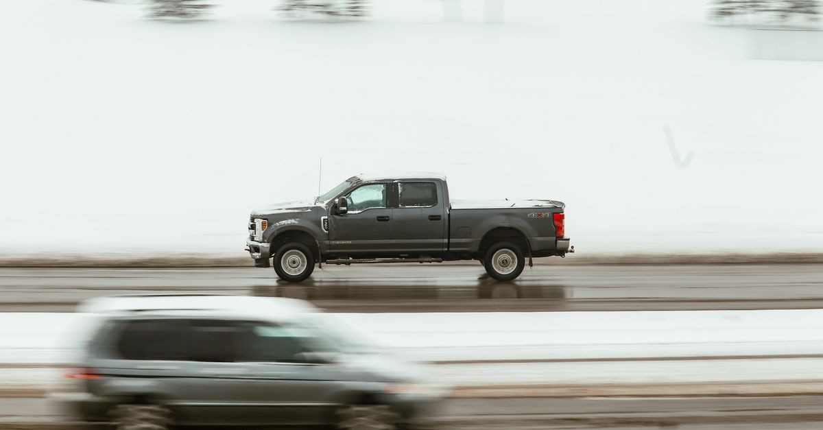 A pickup truck speeds through a snowy highway in Calgary, capturing motion and winter ambiance.